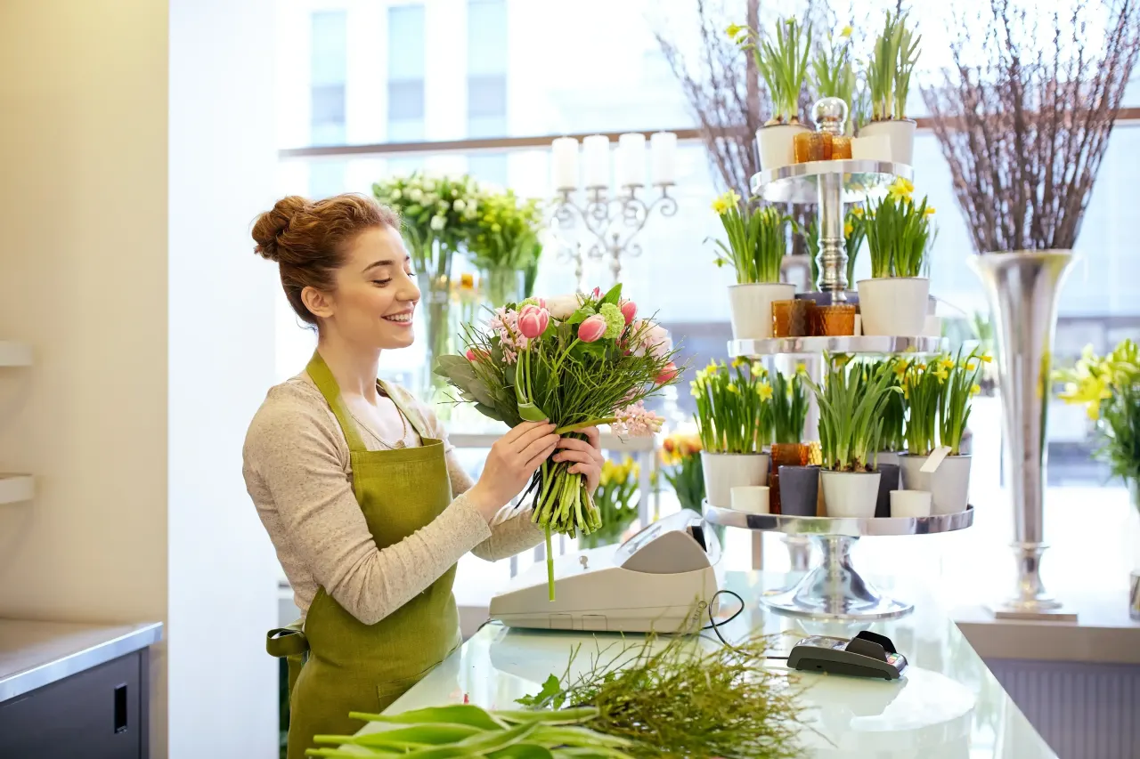 Florist arranging a fresh flower bouquet 